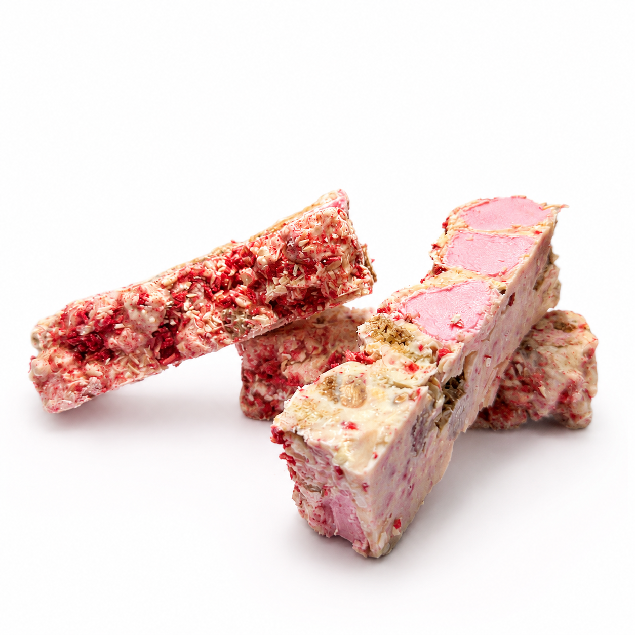 Raspberry Roundabout white chocolate rocky road pieces arranged on a white background with visible pink marshmallows and raspberries.