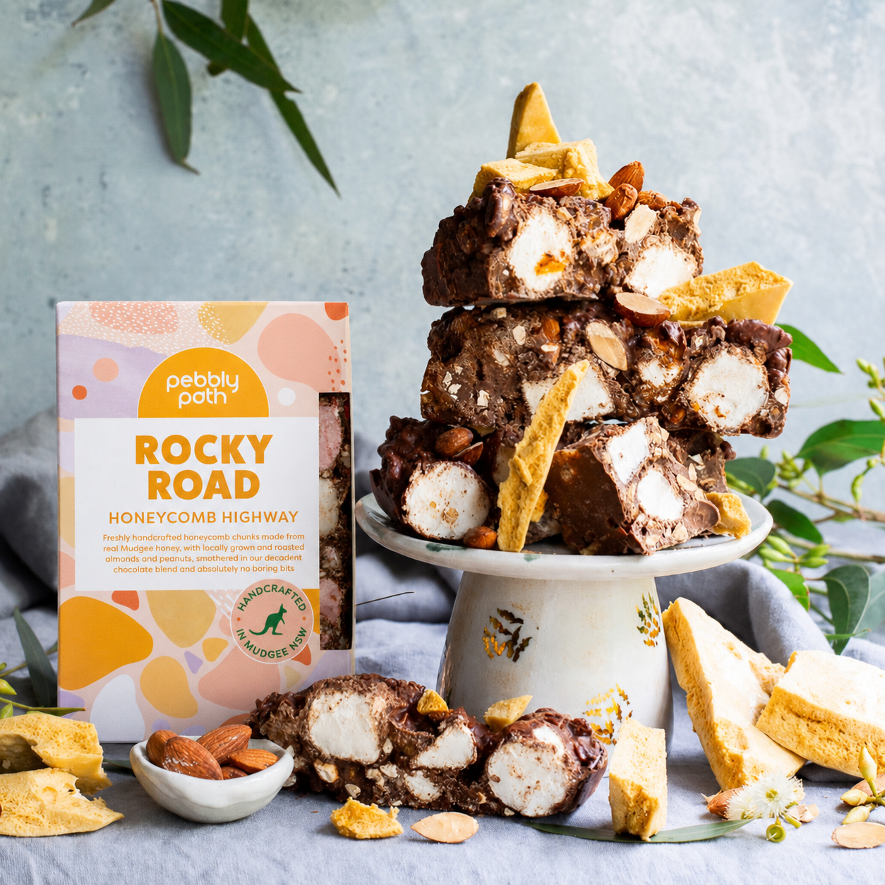 Pebbly Path Honeycomb Highway Rocky Road 200g box with handcrafted chocolate rocky road pieces, honeycomb chunks, marshmallows and roasted almonds displayed on a dessert stand