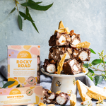 Pebbly Path Honeycomb Highway Rocky Road 200g and 100g boxes displayed with chunky rocky road pieces, honeycomb shards, marshmallows, almonds, and styled native greenery.