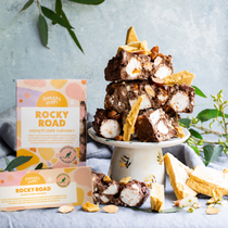 Pebbly Path Honeycomb Highway Rocky Road 200g and 100g boxes displayed with chunky rocky road pieces, honeycomb shards, marshmallows, almonds, and styled native greenery.