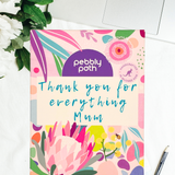Pebbly Path personalised box of custom rocky road chocolate with a handwritten thank you message for Mum on floral gift packaging, displayed on a desk beside a laptop and pen.