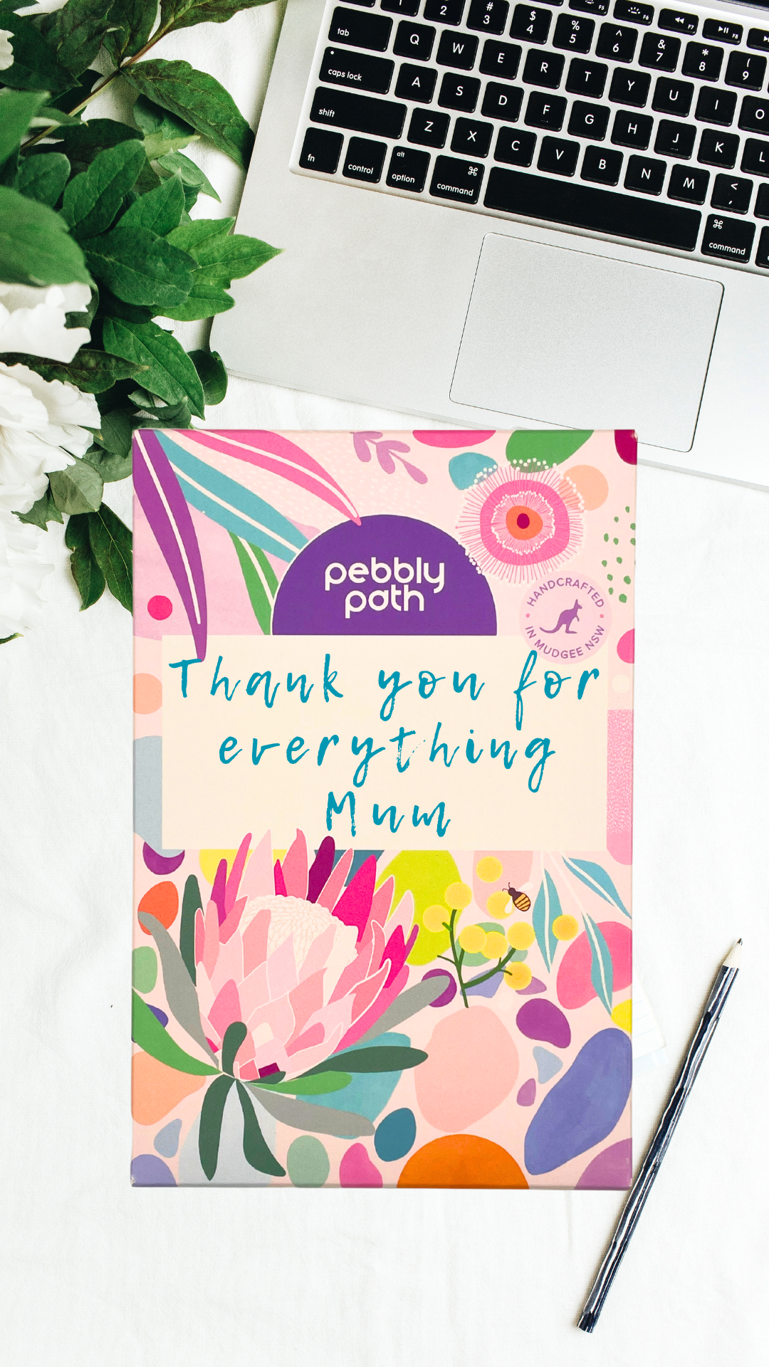 Pebbly Path personalised box of custom rocky road chocolate with a handwritten thank you message for Mum on floral gift packaging, displayed on a desk beside a laptop and pen.