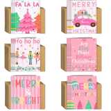 Pebbly Path greeting card collection featuring six pink-themed Christmas card designs with festive illustrations including Christmas trees, a car carrying presents, nutcracker and ballerina characters, holiday typography, and matching kraft envelopes.