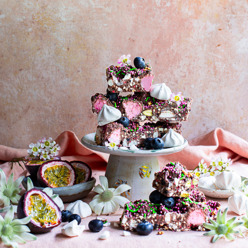 Pebbly Path Pavlova Parkway rocky road pieces served with passionfruit, blueberries, meringue and flowers.