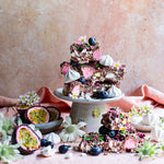 Pebbly Path Pavlova Parkway rocky road pieces served with passionfruit, blueberries, meringue and flowers.