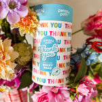 Pebbly Path Pick n Mix Rocky Road Cylinder with a Thank You design, surrounded by colourful flowers in a gift-style arrangement, showcasing a thoughtful appreciation gift for teachers, clients, colleagues, or special occasions.