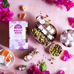 Pebbly Path Turkish Trail Rocky Road 200g box arranged with sliced rocky road and ingredients in a flat lay, presented as a premium chocolate gifting option.