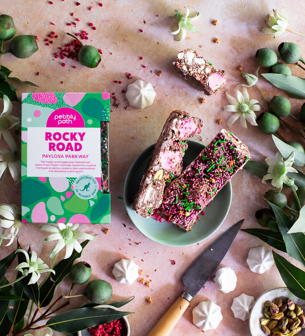 Pebbly Path Pavlova Parkway rocky road 200g box and rocky road pieces arranged with meringue, pistachios and raspberries.