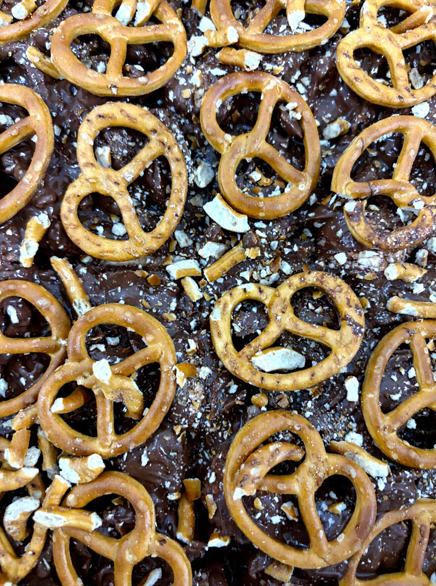 Pebbly Path Salted Caramel Causeway Rocky Road close-up with milk chocolate, crushed pretzels and salted caramel pieces layered across the surface