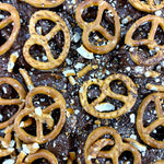 Pebbly Path Salted Caramel Causeway Rocky Road close-up with milk chocolate, crushed pretzels and salted caramel pieces layered across the surface
