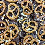 Pebbly Path Salted Caramel Causeway Rocky Road close-up with milk chocolate, crushed pretzels and salted caramel pieces layered across the surface