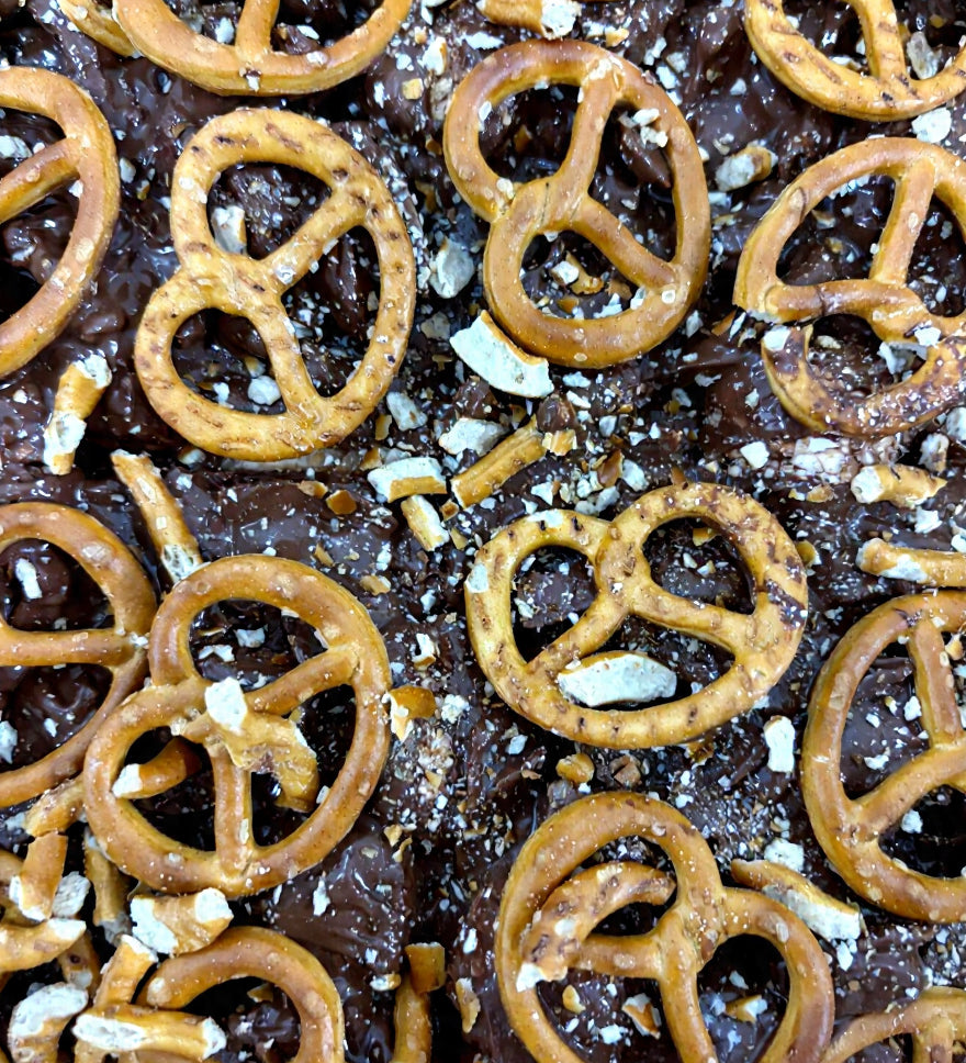 Pebbly Path Salted Caramel Causeway Rocky Road close-up with milk chocolate, crushed pretzels and salted caramel pieces layered across the surface