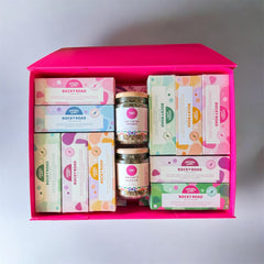 Pebbly Path The Ultimate Rocky Road Lovers Gift Box shown open in a luxe pink keepsake gift box, featuring 10 assorted rocky road bars and 2 ice-cream crumble jars arranged inside for gifting.