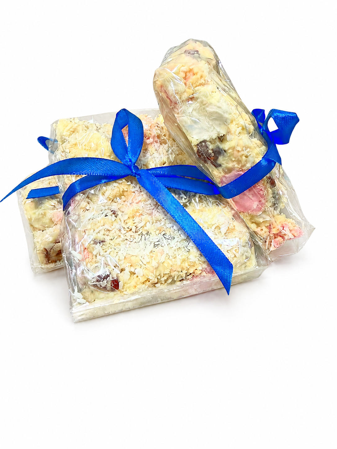 Pebbly Path White Chocolate Signature Recipe Rocky Road gift bundle featuring three individually wrapped packs tied with blue ribbons, displayed together on a white background with visible coconut flakes and white chocolate coating.