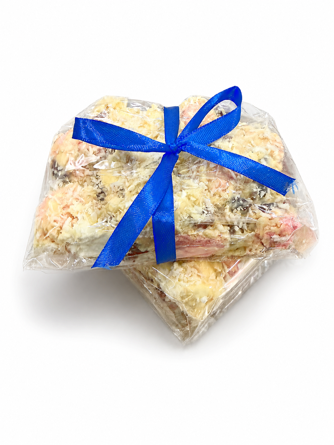Pebbly Path White Chocolate Signature Recipe Rocky Road with two wrapped packs overlapping, tied with a blue ribbon and displayed on a white background with visible coconut flakes, marshmallow, and fruit pieces.