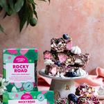 Pebbly Path Pavlova Parkway rocky road 200g and 100g boxes displayed with rocky road pieces, blueberries and meringue.