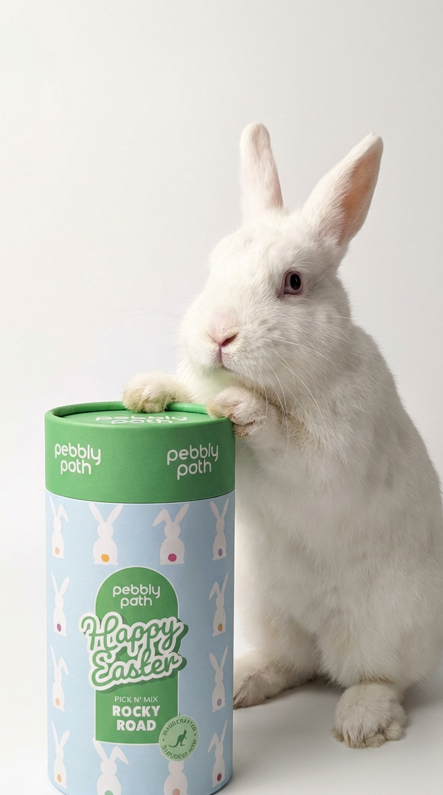 White rabbit with a 'Happy Easter' pet treat container on a white background