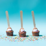 Pebbly Path Hot Chocolate Pops with marshmallows and colourful sprinkles displayed on a pastel blue background with scattered rainbow sprinkles
